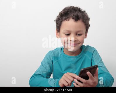 little boy with mobile making a phone call stock photo Stock Photo