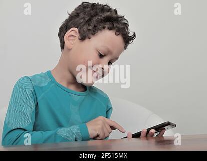 little boy with mobile making a phone call stock photo Stock Photo