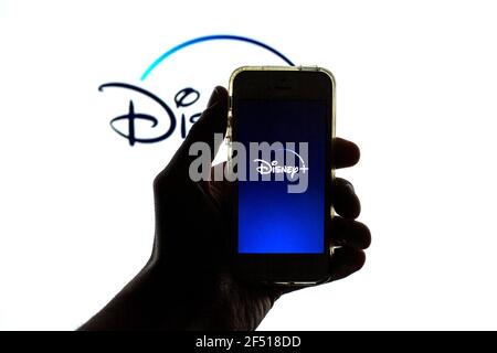 Barcelona, Catalonia, Spain. 23rd Mar, 2021. In this photo illustration the Disney  App seen displayed on a smartphone screen and a Disney  logo in the background Credit: Thiago Prudencio/DAX/ZUMA Wire/Alamy Live News Stock Photo