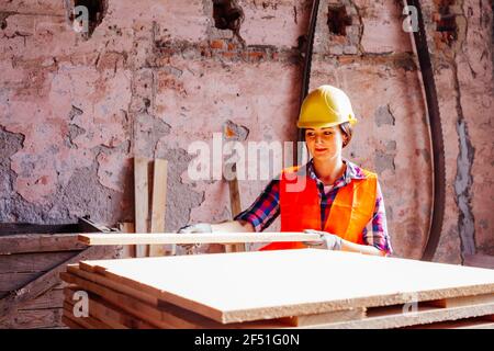 Woman worker at the plant, wearing yellow hard Stock Photo
