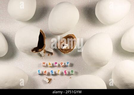 Happy Easter Chocolate Candy Eggs On Snowy White Stock Photo