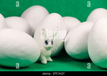 White Rabbit With Large Chocolate Candy Easter Eggs On Green Stock Photo