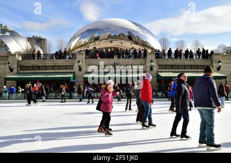 Chicago, Illinois, USA. Ice skaters on the rink provide a foreground to 'Cloud Gate' in Millennium Park. Stock Photo