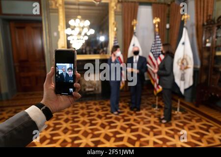 Guests of Gina Raimondo watch via FaceTime as Vice President Kamala Harris swears-in Ms. Raimondo as Secretary of Commerce Wednesday, March 3, 2021, in the Vice President’s Ceremonial Office in the Eisenhower Executive Office Building at the White House. Stock Photo