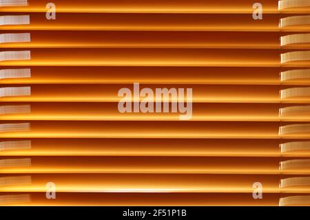 Wood blinds in the window. Natural wood window curtains. Pattern with horizontal wooden lines. Blinds in enlargement. Stock Photo