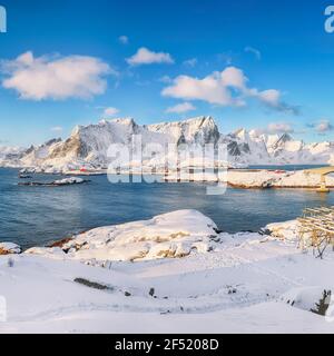 Fabulous winter view of Reine and Sakrisoya villages  seen from Hamnoy and snowy mountaines in background .  Location: Olenilsoya island, Lofoten; Nor Stock Photo