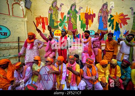 Mathura, India. 23rd Mar, 2021. Devotees singing songs celebrating during the Lathmar Holi Festival of Barsana.The myth behind this festival is related to Hindu God Lord Krishna who as per local belief came from his hometown Nandgaon to Barsana to tease Radha (a Hindu goddess and a consort of the god Krishna) and her friends. For more than 100 years, women of Barsana still maintaining the ritual. Credit: SOPA Images Limited/Alamy Live News Stock Photo