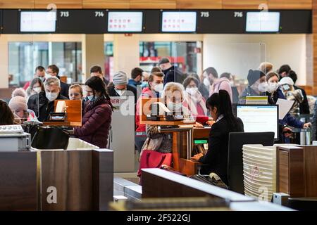 Berlin, Germany. 23rd Mar, 2021. Passengers check in at Berlin Brandenburg Airport in Schoenefeld, Germany, March 23, 2021. Germany will extend its COVID-19 lockdown till at least April 18 with even stricter restrictions during the Easter holidays, Chancellor Angela Merkel announced at a press conference in the early hours of Tuesday. Credit: Stefan Zeitz/Xinhua/Alamy Live News Stock Photo