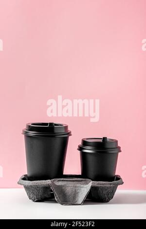 Two recyclable coffee cups in a holder to go Stock Photo