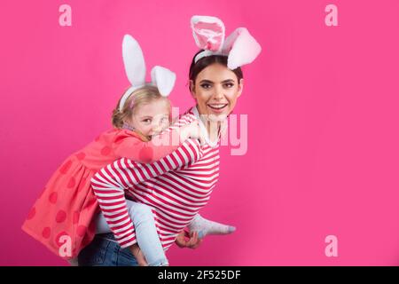 Happy easter. Two sisters hunting for Easter eggs. Girls with bunny ears. Stock Photo