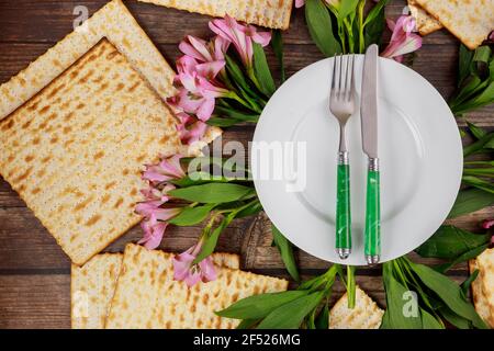 Dinner table setting with flowers for Passover. Jewish holiday Pesach. Stock Photo