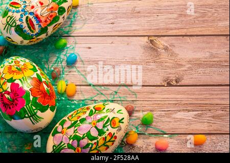 decorated eggs and jelly beans on wood background Stock Photo