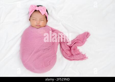 Baby girl wrapped in pink outlet blanket