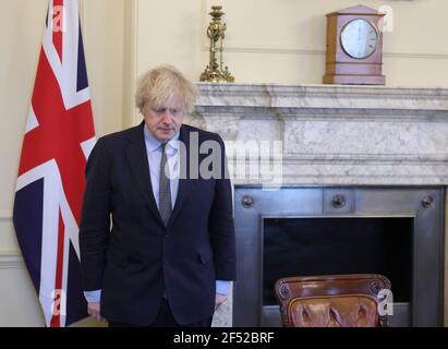 (210324) -- LONDON, March 24, 2021 (Xinhua) -- British Prime Minister Boris Johnson observes one minute's silence for National Day of Reflection at 10 Downing Street in London, Britain, on March 23, 2021. Britain on Tuesday marked one year since British Prime Minister Boris Johnson announced the first coronavirus lockdown in the country last year. On March 23, 2020, Johnson unveiled measures to stop the spread of COVID-19. A national minute's silence was held at midday as part of a day of reflection. Britons are also encouraged to stand on their doorsteps at 2000 GMT with phones, candles an Stock Photo