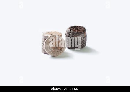 Isolated compacted peat pellets (pod) for seed starting are used by gardeners. Peat is harvested unsustainably and has led to irreversible damage. Coc Stock Photo