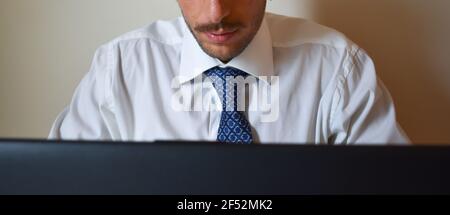 Focused Caucasian businessman working on his laptop Stock Photo
