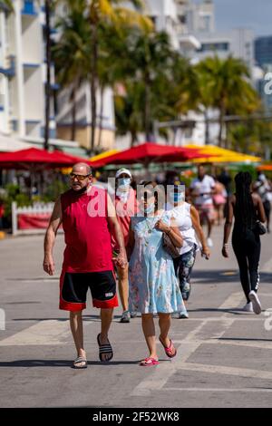 Mature couple holding hands walking in Miami Beach 2021 Spring Break Stock Photo
