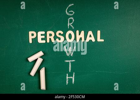 Personal Growth Concept. Letters of the alphabet on a green chalk board. Stock Photo