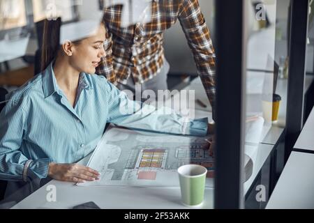 Two designers working at a new building plan Stock Photo