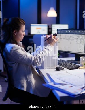 Engineer constructor designer architect developing prototype component in CAD program working in business office. Overworked woman studying new project model using innovative technology Stock Photo