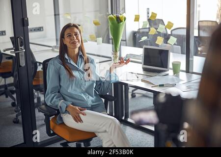 Joyous employee posing for the camera in the workplace Stock Photo