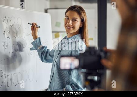 Joyous female engineer posing for the camera in the workplace Stock Photo