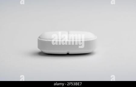 Macro photography of an Oval white tablet that can be divided. Stock Photo