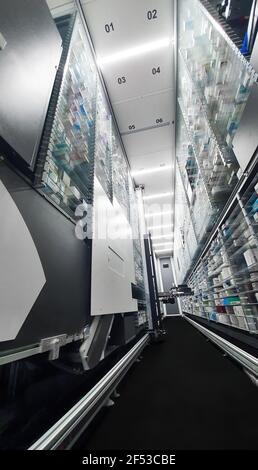 Modern pharmacy storage room and  robot hand s are arranging and storing out drugs in a pharmacy Stock Photo