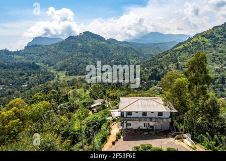 View of the mountain valley and houses among the forest and tea plantations on the island of Sri Lanka Stock Photo