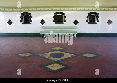 Ticket selling windows of the old historic art deco retired railway station at Townsville, Queensland, Australia, with geometric black and white tiles Stock Photo