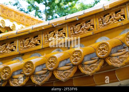 Many Chinese lanterns and gods on Roof top of Chinese houses against blue sky. Stock Photo