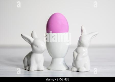 Side view of  porcelain Easter bunnies Porcelain Egg Cups with  Easter egg.On a white background . Stock Photo