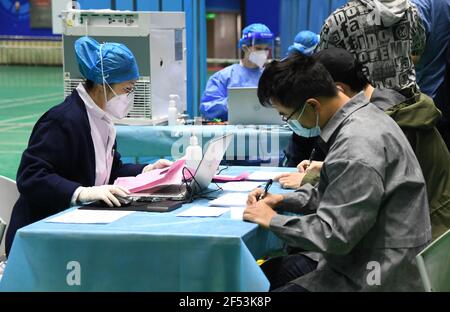 Beijing, China. 24th Mar, 2021. A medical staff checks the information of students to receive the COVID-19 vaccine at the Beihang University in Beijing, capital of China, March 24, 2021. Credit: Ren Chao/Xinhua/Alamy Live News Stock Photo
