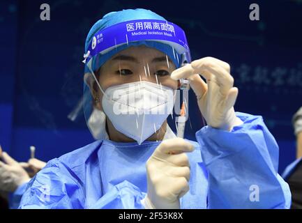 Beijing, China. 24th Mar, 2021. A medical staff prepares a dose of COVID-19 vaccine at the Beihang University in Beijing, capital of China, March 24, 2021. Credit: Ren Chao/Xinhua/Alamy Live News Stock Photo