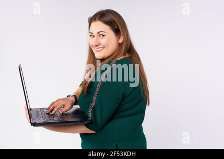 Close-up portrait of plus size, nice attractive pretty focused cheerful blonde haired large lady. IT specialist holding in hands laptop isolated on Stock Photo