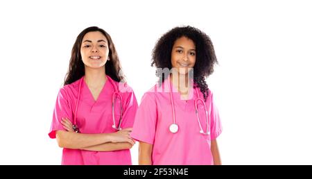 Two teenager doctor students with pink uniform isolated on a white background Stock Photo