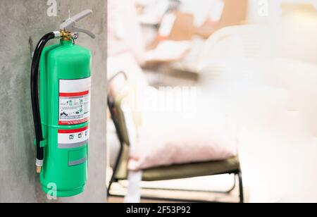 Fire extinguishers hanging on the wall available in fire emergencies at the public are as departmentstore. Stock Photo