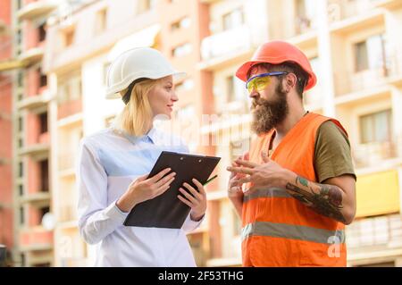 Construction industry. Successful deal concept. Foreman established supply of building materials. Expert and builder communicate about supply building Stock Photo