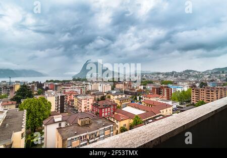 Panoramic view of Lugano city with stormy sky on rainy day, Ticino, Switzerland Stock Photo