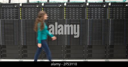 Sofia, Bulgaria - Mar 23 2021: Installing the supercomputer in Sofia Tech park - the biggest in Eastern Europe. A woman passing through the mainframe Stock Photo