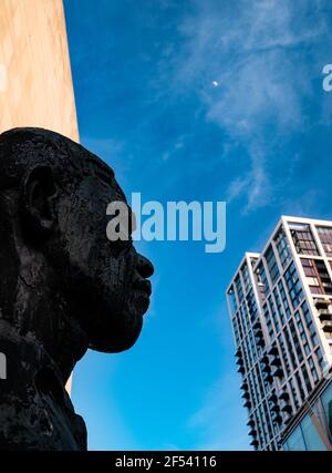 Bronze bust of Nelson Mandela by Iain Walters, ex president of South Africa, at Royal Festival Hall, Southbank, London against a bright blue sky Stock Photo