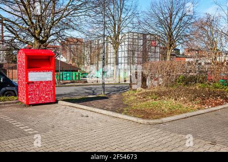 SOLINGEN, GERMANY - FEBRUARY 19, 2021: Red clothing bank to collect old clothes and shoes Stock Photo