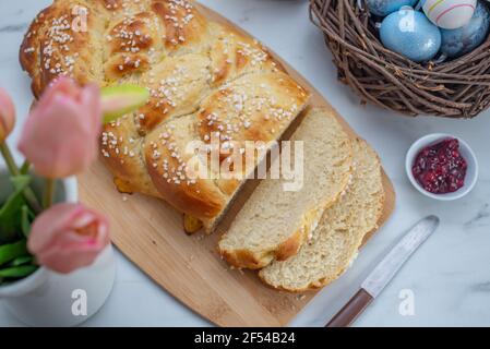 Sweet home made braided yeast bun for easter on a table Stock Photo