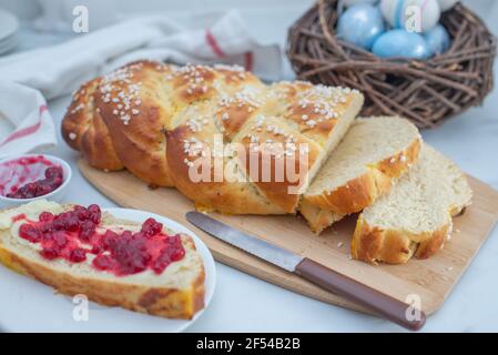 Sweet home made braided yeast bun for easter on a table Stock Photo