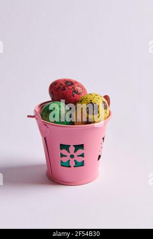 colored eggs for Easter in a bucket Stock Photo