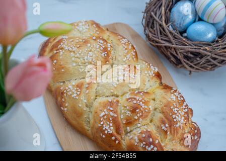 Sweet home made braided yeast bun for easter on a table Stock Photo