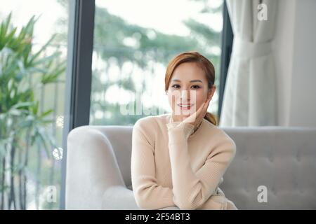 Relaxed calm woman resting breathing fresh air feeling mental balance enjoying wellbeing at home on sofa Stock Photo