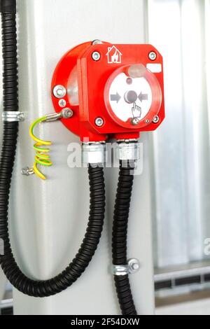 Fire alarm button in industrial room metal hangar Stock Photo