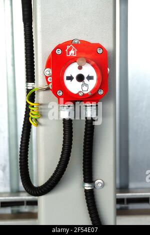 Fire alarm button in industrial room metal hangar Stock Photo