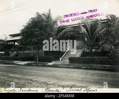 Manila, Philippines. View of a private house with terrace and palm trees on a street Stock Photo